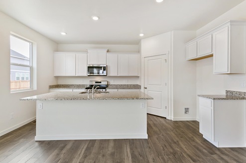 white cabinet kitchen with an island