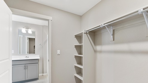 walk in closet with shelves in the bathroom
