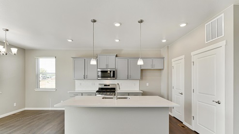 stainless steel appliance kitchen with an island with pendant light above