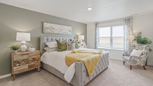 staged main bedroom with a window and carpet flooring