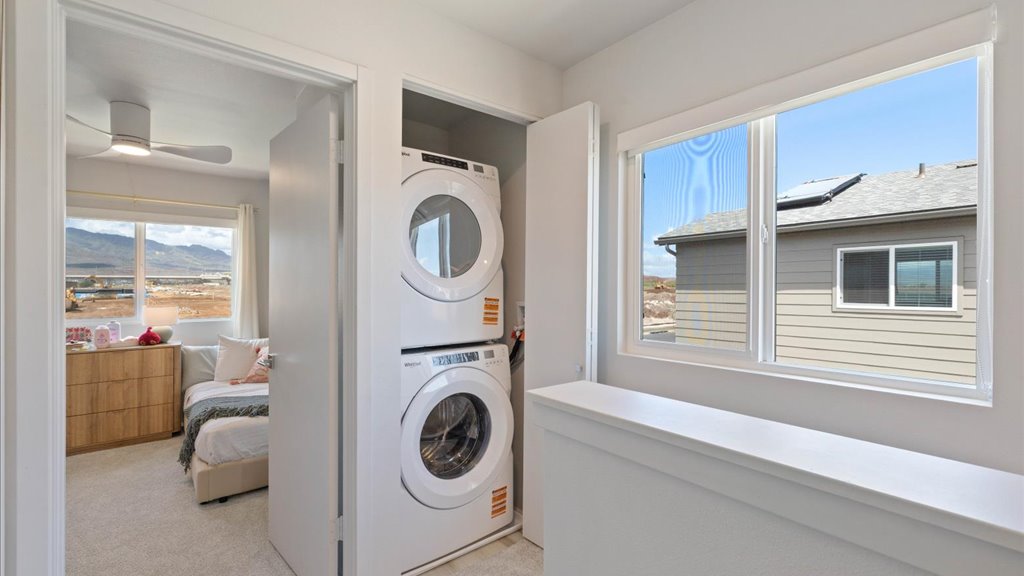 Interior laundry in hallway with window