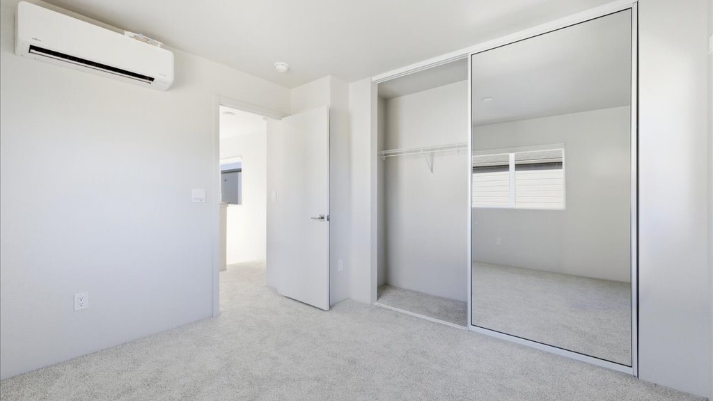 Interior bedroom with large window and sliding door closet