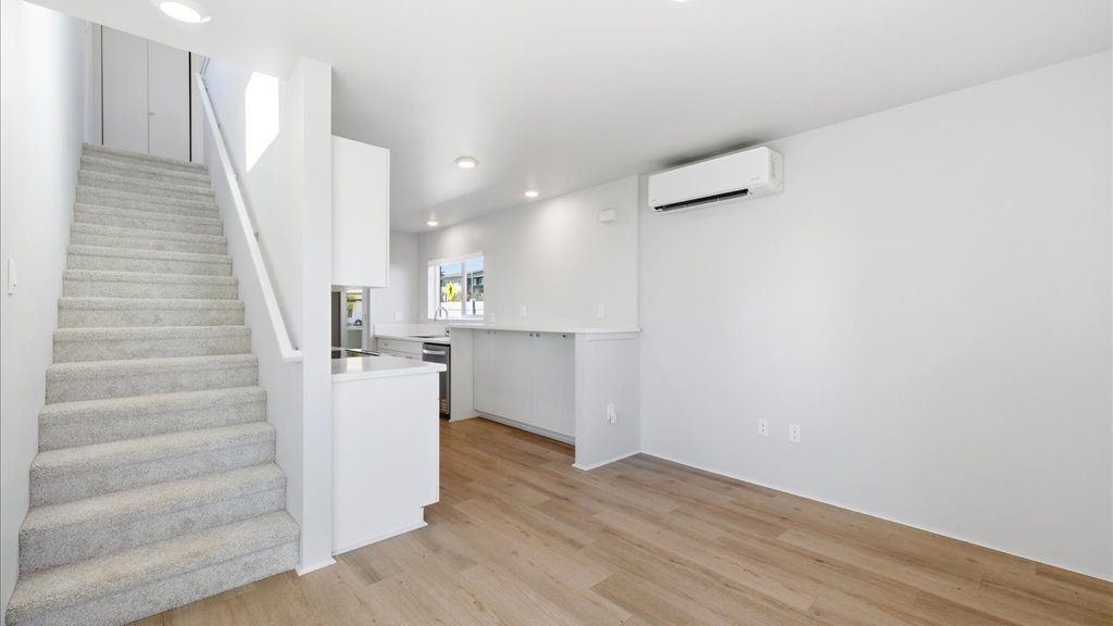 Interior living room open to stairwell and kitchen