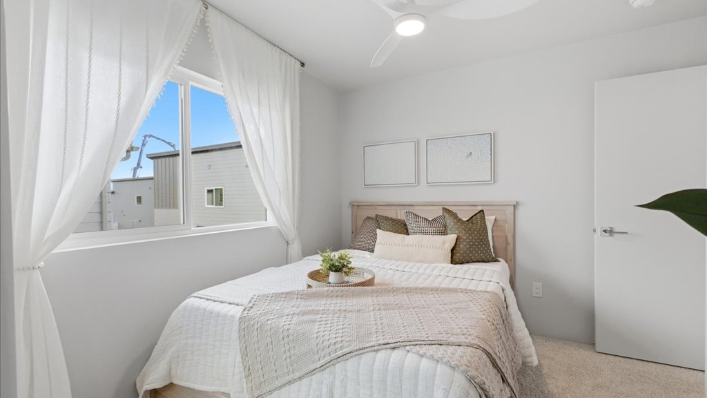 Interior bedroom with sliding door closet and large window