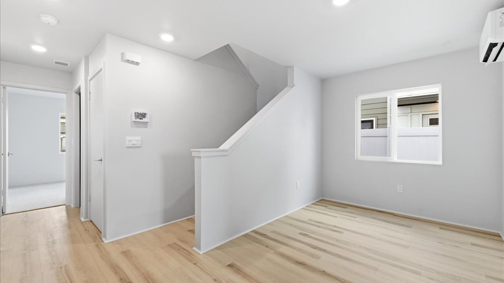 Interior bonus space and play room with large window open to stairs