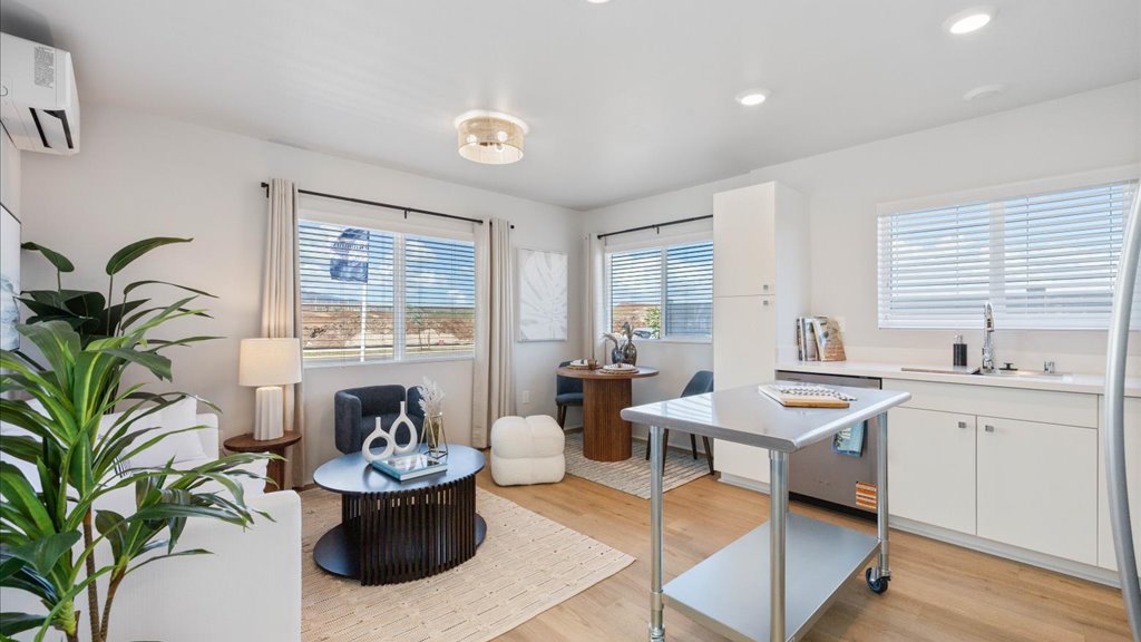Interior kitchen with stainless steel appliances and stainless-steel island open to living room