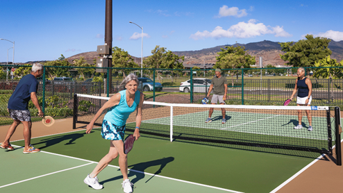 Amenity pickle ball court with people playing pickleball