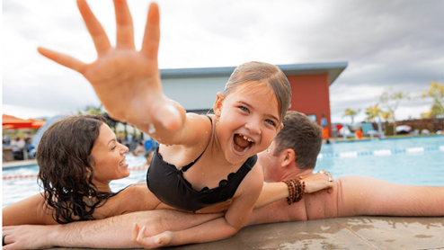 Amenity pool with child and parents swimming