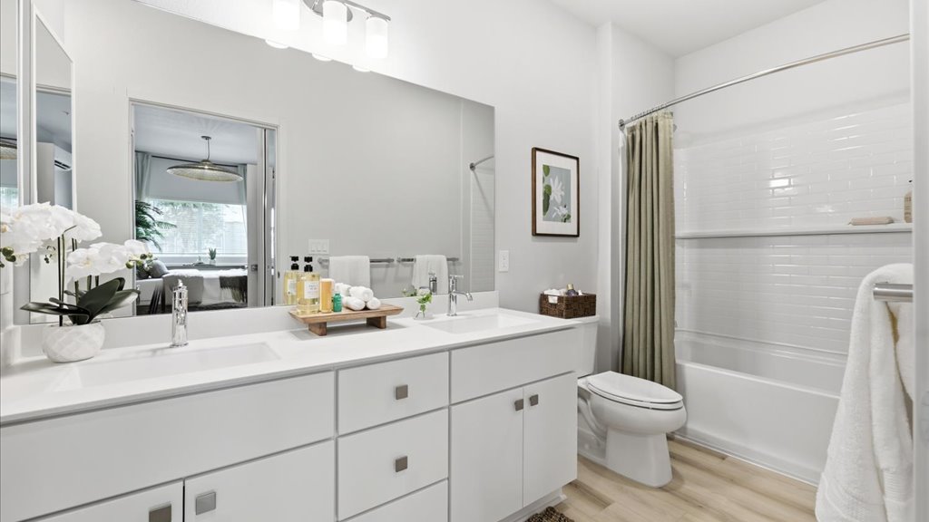 Interior bathroom with vanity sinks and shower tub combination