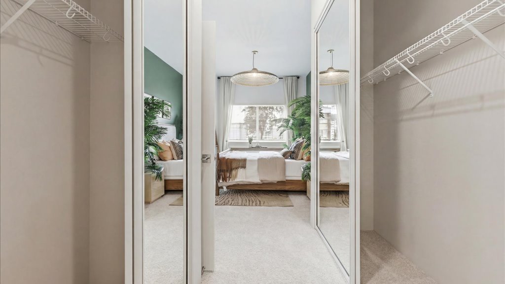 Interior bedroom with large window and sliding door closet
