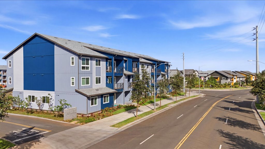Exterior three story building with blue and gray wood cladding