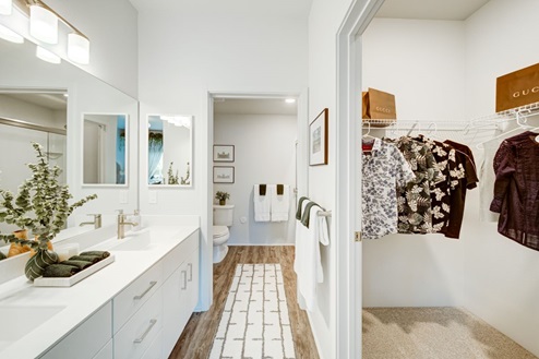 Interior bathroom with two sinks and walk in closet