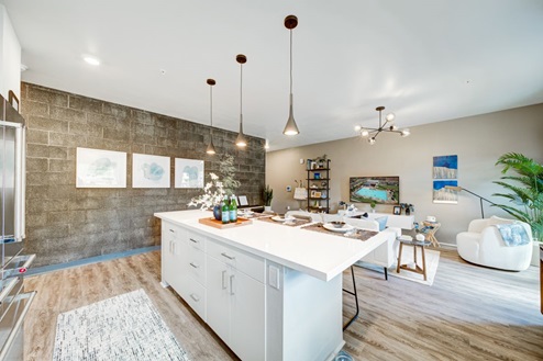 Interior kitchen with central island open to living room