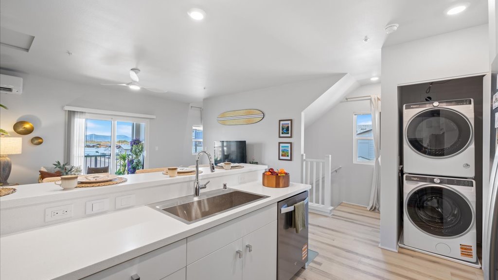 Interior kitchen with stainless steel appliances and laundry area