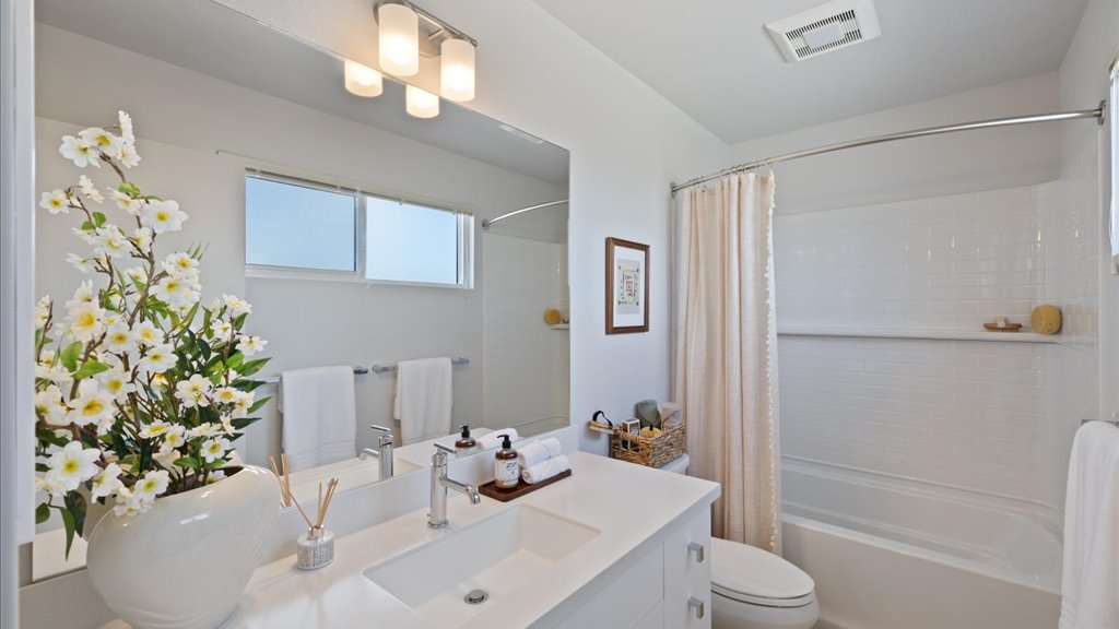 Interior bathroom with sink and toilet and shower tub combination