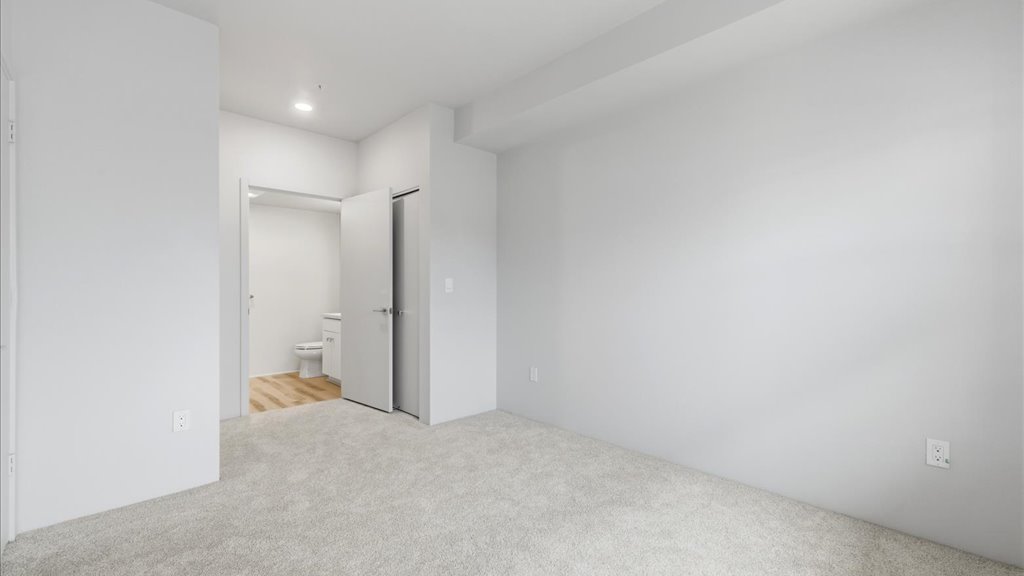 Interior bedroom with his and hers closet and bathroom