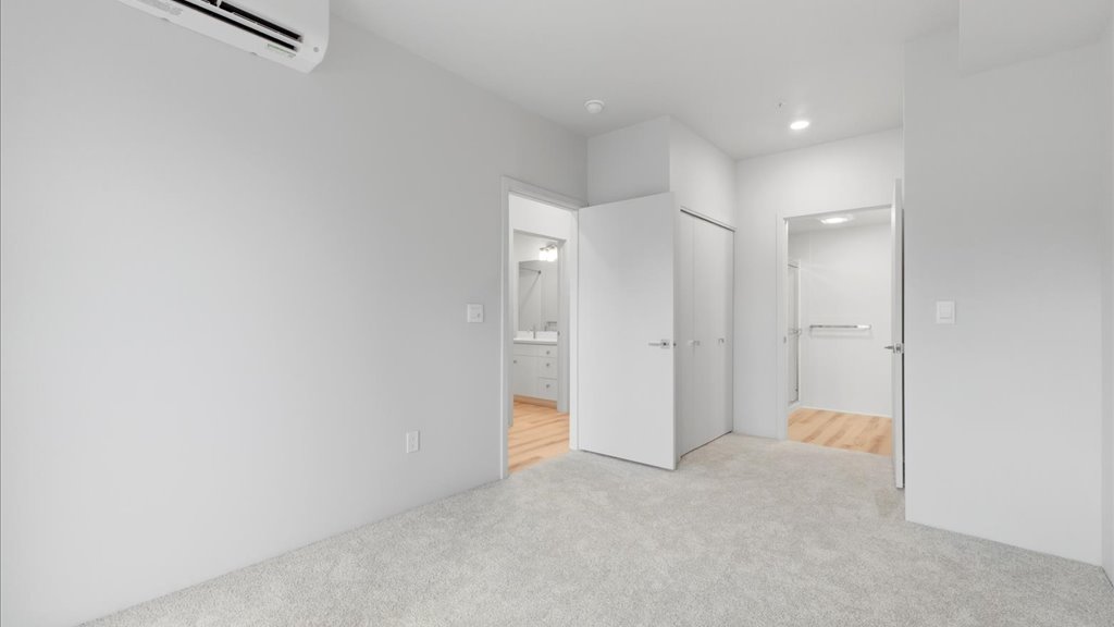 Interior bedroom with his and hers closet and bathroom