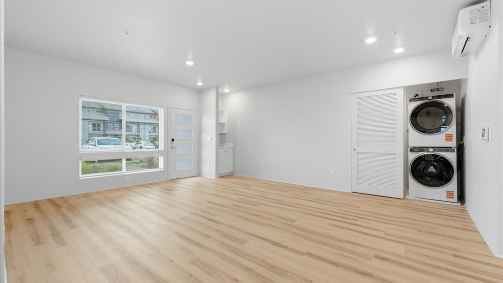 Interior kitchen open to living room and laundry