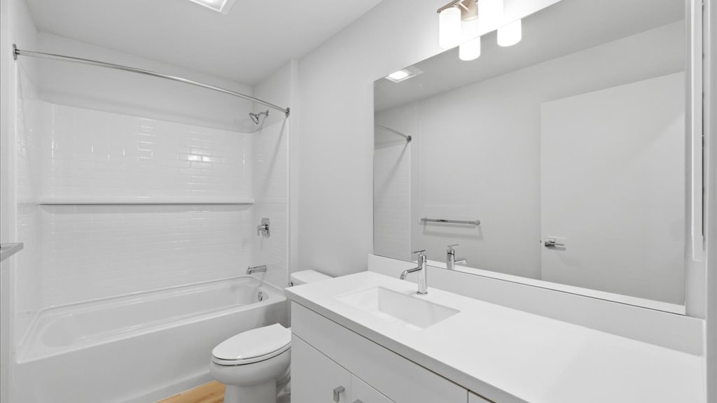 Interior bathroom with toilet and shower and tub combination