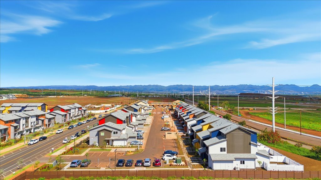 Exterior three story building with yellow and blue wood cladding
