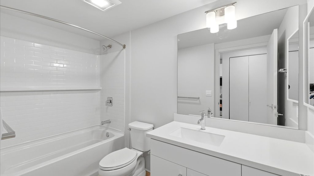Interior bathroom with toilet vanity and shower tub combination