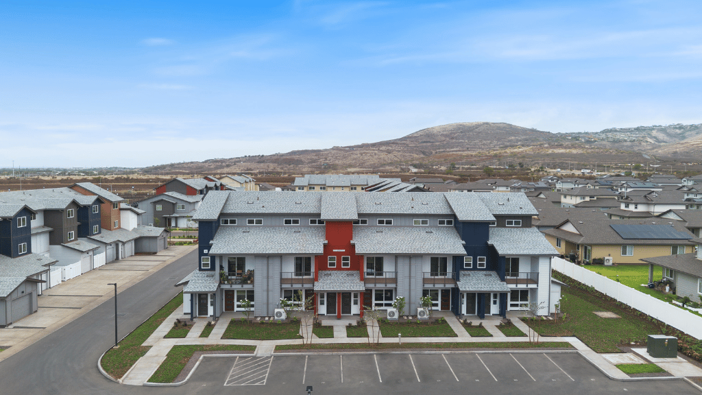 Exterior three story building with red and blue wood cladding