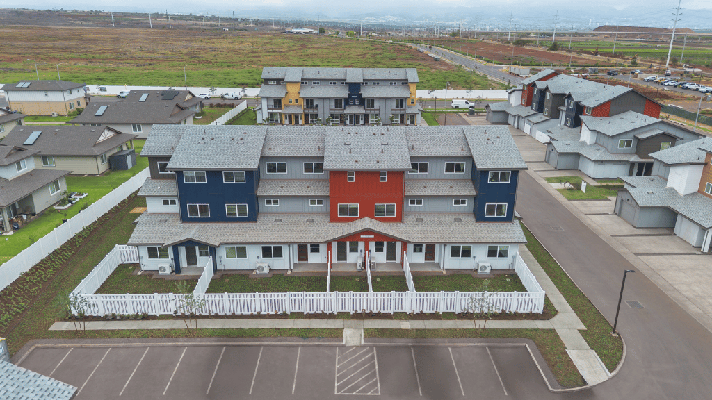Exterior three story building with red and blue wood cladding