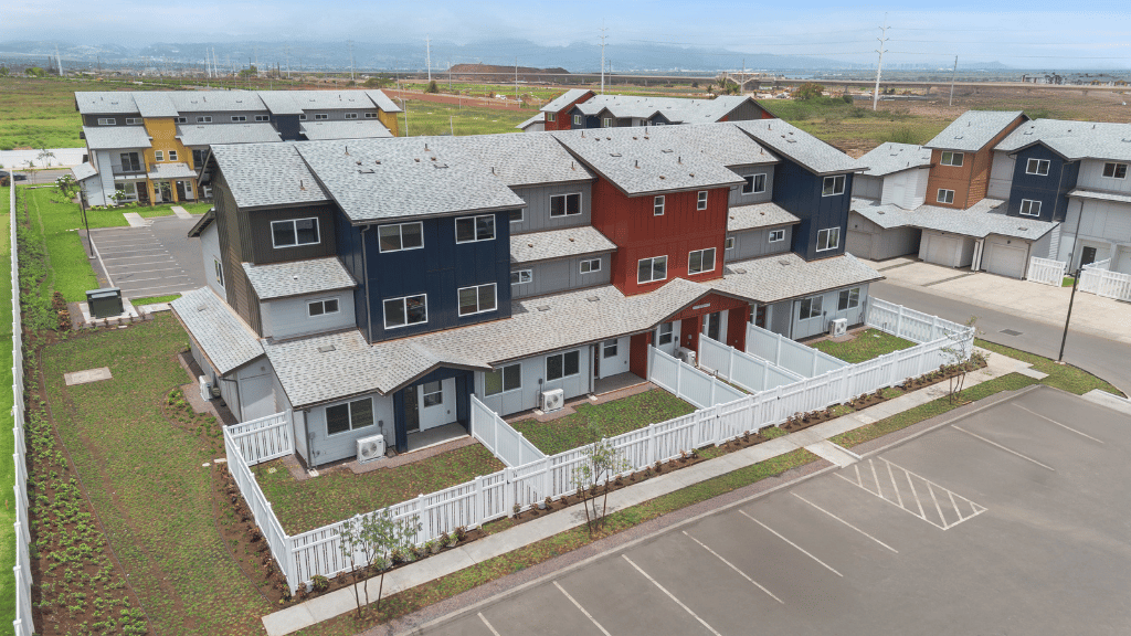 Exterior three story building with red and blue wood cladding