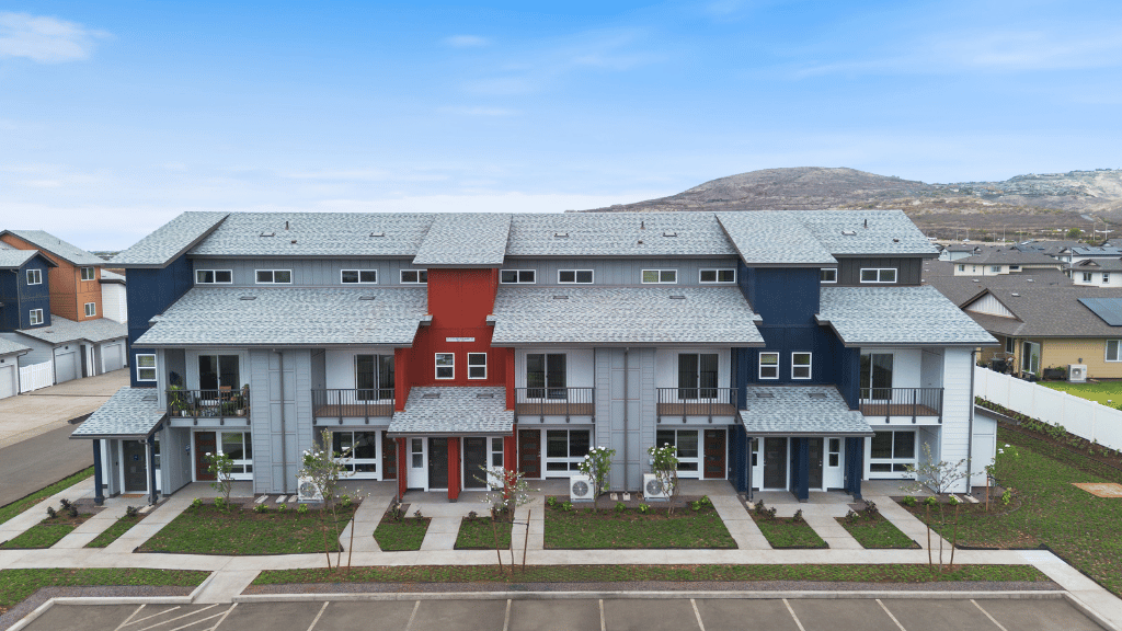 Exterior three story building with red and blue wood cladding