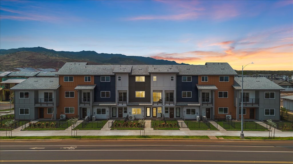 Exterior three story building with blue and gray wood cladding