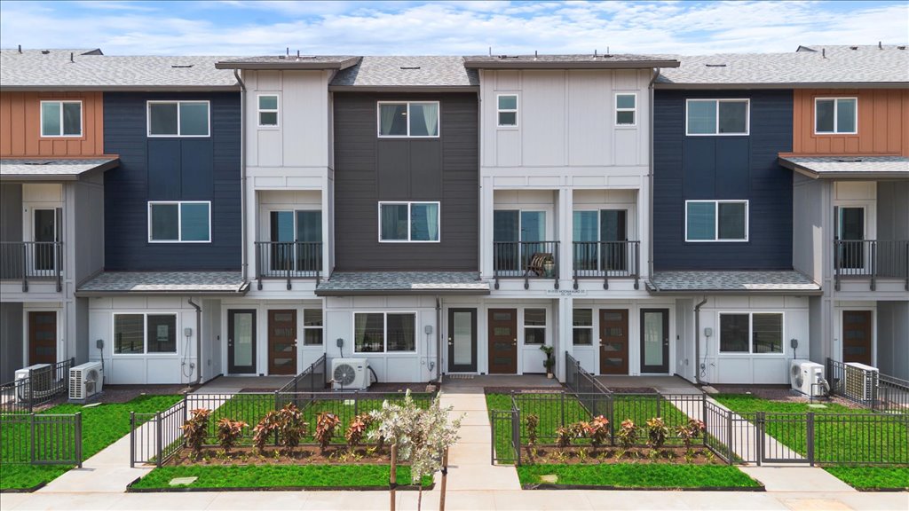 Exterior three story building with blue and gray wood cladding