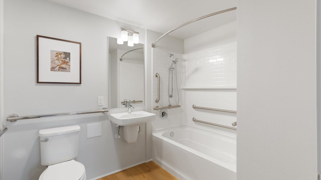 Interior ADU bathroom with shower tub combination and pedestal sink