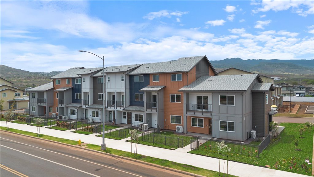 Exterior three story building with blue and gray wood cladding
