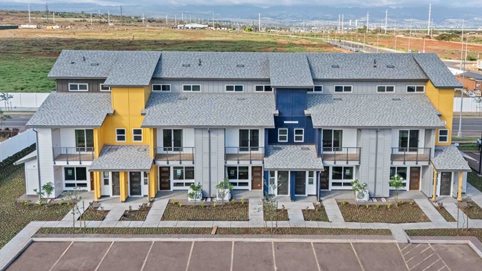 Exterior three story yellow, blue and grey building