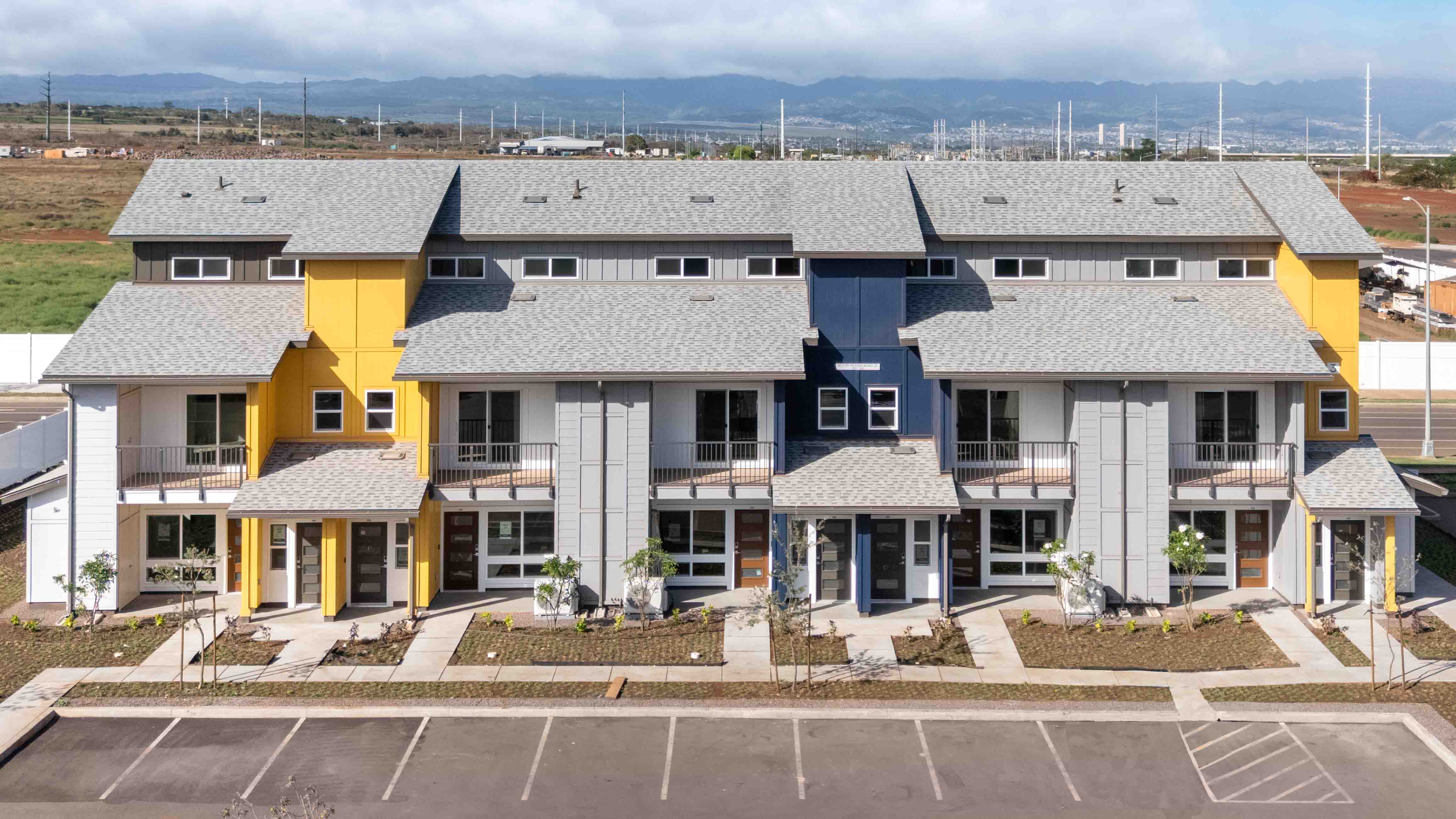 Exterior three story blue and yellow building