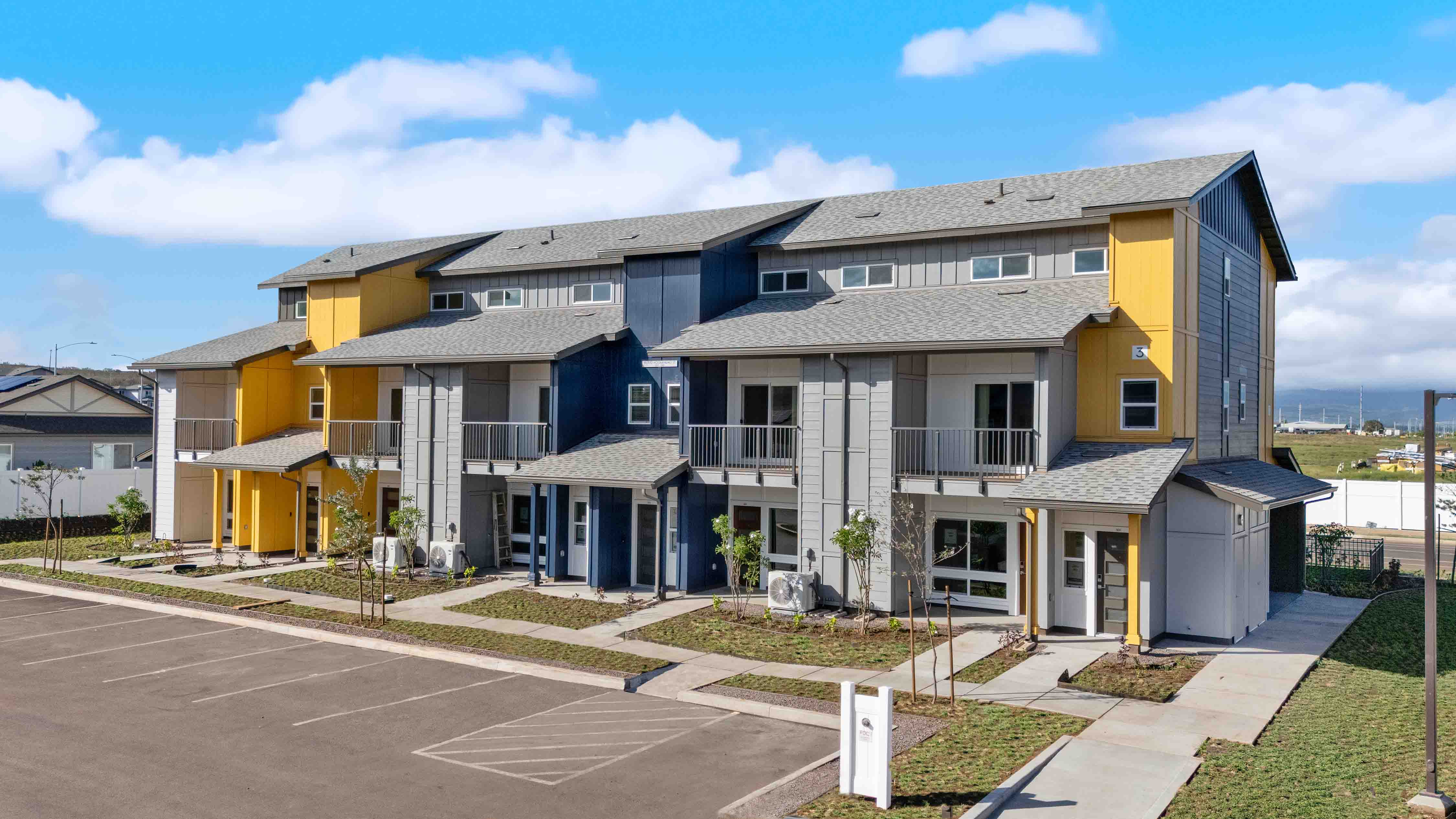 Exterior three story blue and yellow building