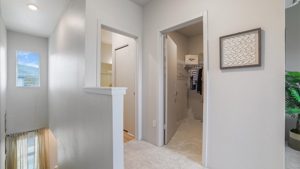 Interior primary bathroom and walk in closet