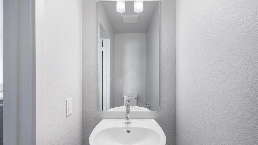 Interior powder room with toilet and vanity sink