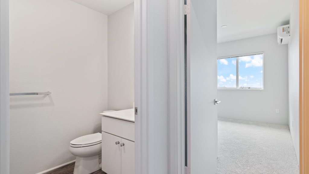 Interior bedroom with large window open to bathroom
