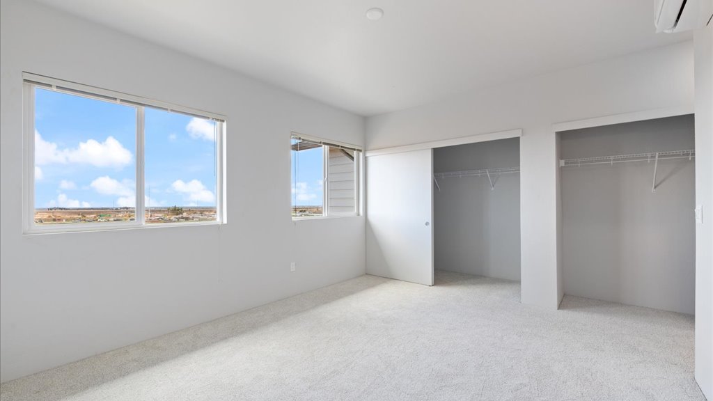 Interior bedroom with large window and closets