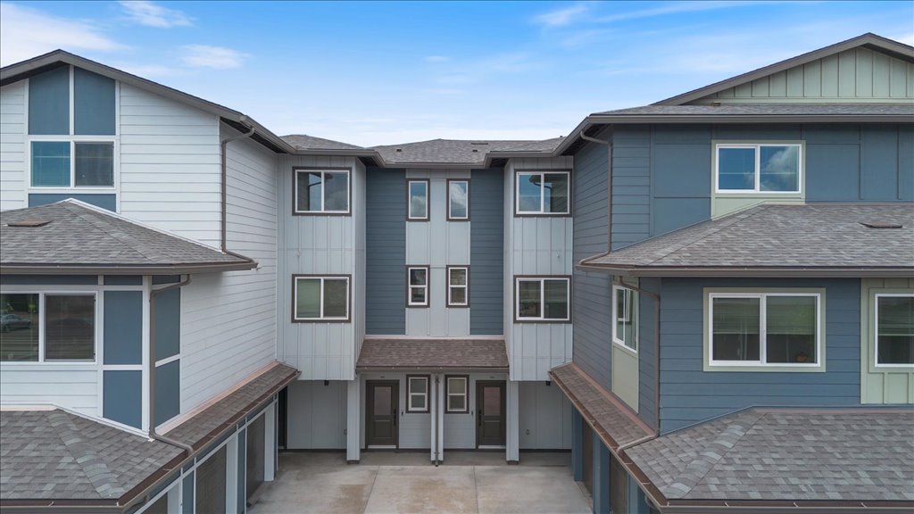 Exterior three story building with blue wood cladding