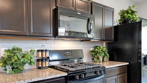 kitchen with island and granite countetop and black appliances