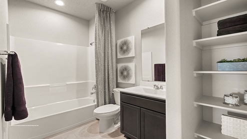 secondary bathroom with tub and shelves