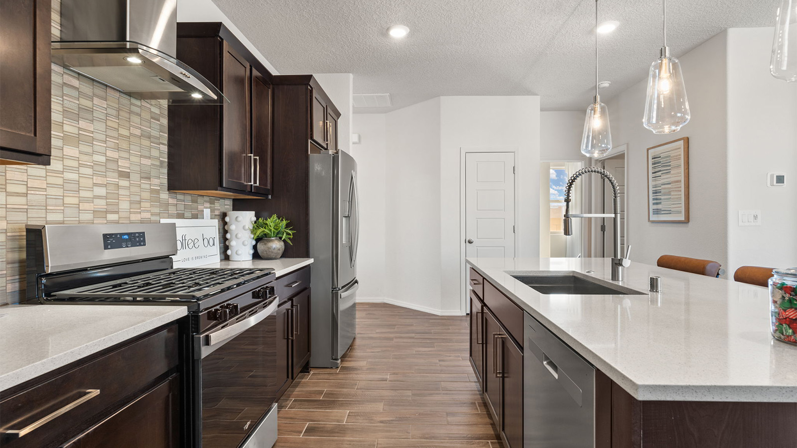 New appliance suite included, with our kitchen island, a sink, seating that anchors our kitchen, pantry, near dining, living rooms