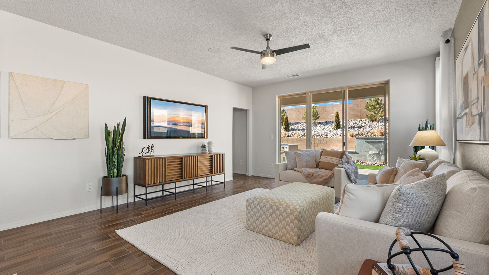 Living room by D.R. Horton showcases connectivity to main areas, and rear patio and backyard access