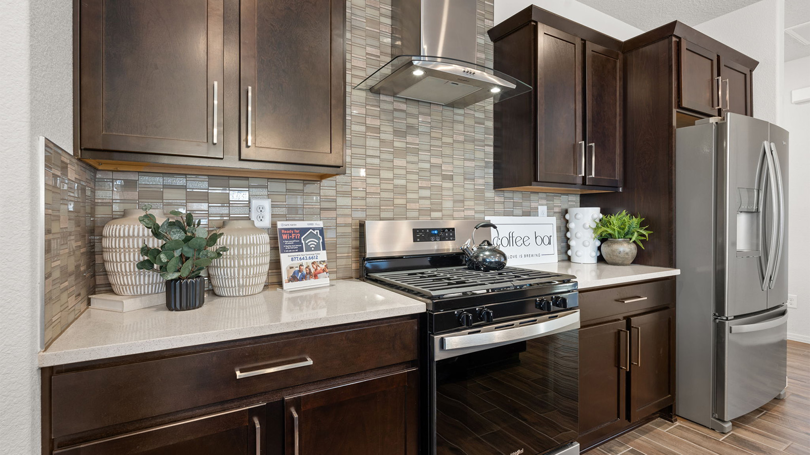 Kitchen island in D.R. Horton layout connects dining, main living areas, and outside with efficient flow and modern designs