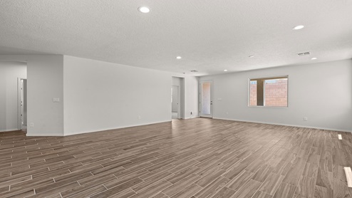 living area with windows and door leading backyard