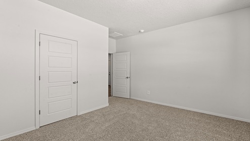 first secondary bedroom with two windows and carpet floors with closet