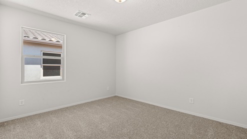 second secondary bedroom with two windows and carpet floors with closet