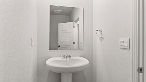 Half bath with pedestal sink and commode